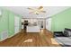 Bright, open-concept living room with hardwood floors, ceiling fans, and a charming central island at 11918 Dietz Dr # 28, Tampa, FL 33626