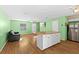 Cozy living room with wood flooring, ceiling fan, and island open to kitchen and dining at 11918 Dietz Dr # 28, Tampa, FL 33626