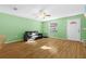 Living room with wood-look floors, a black sofa and a small window at 11918 Dietz Dr # 28, Tampa, FL 33626