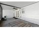 Enclosed patio with ceiling fan and access to the backyard with a mower ready to go at 11918 Dietz Dr # 28, Tampa, FL 33626