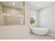Bright bathroom showcases a glass enclosed shower and a standalone soaking tub at 12817 Daleridge Pl, Riverview, FL 33579