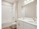 Bright bathroom featuring double vanity with white cabinets, modern fixtures, and a tub with tiled surround at 12817 Daleridge Pl, Riverview, FL 33579