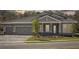 Charming single-story home boasts a paved driveway and a welcoming front porch with stone accents and manicured landscaping at 12817 Daleridge Pl, Riverview, FL 33579