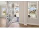 Welcoming foyer showcasing a glass front door, views of the front yard, and wood-look floors at 12817 Daleridge Pl, Riverview, FL 33579