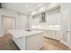 Modern kitchen featuring a large island, white cabinets, and stainless-steel appliances at 12817 Daleridge Pl, Riverview, FL 33579