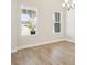 Bright dining room with wood-look floors, natural light, and a view of the porch from its two large windows at 12817 Daleridge Pl, Riverview, FL 33579