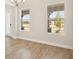 Bright dining room with wood-look floors, natural light, and a view of the porch from its two large windows at 12817 Daleridge Pl, Riverview, FL 33579