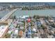 Aerial view of a charming single-story home with mature trees, near to waterfront and causeway at 129 94Th Ave, Treasure Island, FL 33706