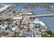 The house is in an aerial view of the location near the bay, bridge, and coastal community at 129 94Th Ave, Treasure Island, FL 33706