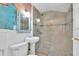 Bathroom with a modern glass-enclosed shower and a pedestal sink in a compact space at 129 94Th Ave, Treasure Island, FL 33706