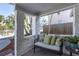 Relaxing front porch with a cozy bench, decorative pillows, and a view of the palm trees at 129 94Th Ave, Treasure Island, FL 33706