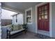 Cozy front porch with comfortable seating, a red front door, and a welcoming entrance at 129 94Th Ave, Treasure Island, FL 33706