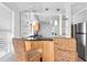 Bright kitchen area with bar seating, modern pendant lighting, and open access to adjacent living spaces at 129 94Th Ave, Treasure Island, FL 33706