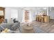 Open-concept living space featuring hardwood floors, ample seating, and seamless flow to the kitchen at 129 94Th Ave, Treasure Island, FL 33706