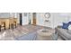 Stylish living room with a cozy seating area, hardwood floors, and seamless flow into the kitchen area at 129 94Th Ave, Treasure Island, FL 33706