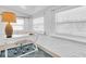 Bright office features a white desk, rolling chair, large lamp, and natural light from the window at 129 94Th Ave, Treasure Island, FL 33706