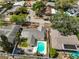 Aerial view of a neighborhood showcasing a home with a backyard pool, patio, and lush landscaping at 13111 114Th St, Largo, FL 33778