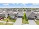 Aerial view of a neighborhood showcasing single-story homes with well-manicured lawns and two-car garages at 14916 Imperial Purple Ln, Wimauma, FL 33598