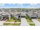 Aerial view of a suburban neighborhood showcasing well-maintained homes with landscaped yards and driveways at 14916 Imperial Purple Ln, Wimauma, FL 33598