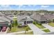 Overhead view of a suburban neighborhood featuring well-maintained homes with landscaped yards and driveways at 14916 Imperial Purple Ln, Wimauma, FL 33598