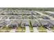 Expansive aerial view of a suburban neighborhood with well-maintained homes and a nearby lake at 14916 Imperial Purple Ln, Wimauma, FL 33598