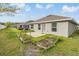 A spacious backyard featuring a swing frame and garden beds, with a well-maintained lawn at 14916 Imperial Purple Ln, Wimauma, FL 33598