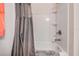 The bathroom showcases a tub-shower combo and a decorative gray shower curtain at 14916 Imperial Purple Ln, Wimauma, FL 33598