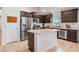 Bright kitchen features stainless appliances, dark cabinetry, island and tile flooring at 14916 Imperial Purple Ln, Wimauma, FL 33598