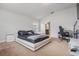 Spacious main bedroom with large bed, minimalist design, and ensuite bathroom at 14916 Imperial Purple Ln, Wimauma, FL 33598