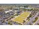 Aerial view of community center with pool, lawn bowling, putting green, and a large parking area at 1735 Flamingo Ln, Sun City Center, FL 33573