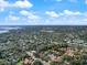 Aerial view of residential neighborhood with lush trees and blue skies overhead at 1908 Bayshore Ct, Safety Harbor, FL 34695