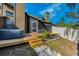 Home backyard featuring a hot tub, screened-in porch and steps leading into yard at 1908 Bayshore Ct, Safety Harbor, FL 34695
