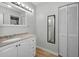 Bathroom with a vanity, an oversized mirror with Hollywood lighting, and a linen closet at 1908 Bayshore Ct, Safety Harbor, FL 34695