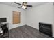 Bedroom features a dark laminate floor, window, closet, and a ceiling fan at 1908 Bayshore Ct, Safety Harbor, FL 34695