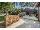 Community picnic area featuring a stone grill and clubhouse building with a covered seating area for residents' enjoyment at 1908 Bayshore Ct, Safety Harbor, FL 34695