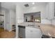 Bright kitchen with granite countertops, stainless steel appliances and an opening to the living space at 1908 Bayshore Ct, Safety Harbor, FL 34695