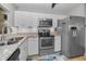 Updated kitchen with stainless steel appliances, light countertops, and white cabinetry at 1908 Bayshore Ct, Safety Harbor, FL 34695
