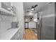 Galley kitchen with stainless steel appliances and a bar looking into the living area at 1908 Bayshore Ct, Safety Harbor, FL 34695