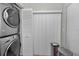 Conveniently located laundry area with stacked washer and dryer and storage options at 1908 Bayshore Ct, Safety Harbor, FL 34695
