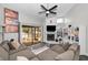 Bright living room features a sliding glass door to the back porch, a fireplace, and built-in bookshelves at 1908 Bayshore Ct, Safety Harbor, FL 34695