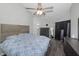 Main bedroom with vaulted ceiling and blue bedding complemented by modern furnishings at 1908 Bayshore Ct, Safety Harbor, FL 34695