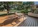 Charming deck area with pond views, featuring a table with chairs and lush landscaping for serene outdoor living at 1908 Bayshore Ct, Safety Harbor, FL 34695