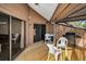 Covered patio features a wooden deck, grill, and outdoor furniture; perfect for entertaining at 1908 Bayshore Ct, Safety Harbor, FL 34695
