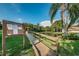 Neighborhood pond view with community notice board and a small pier at 1908 Bayshore Ct, Safety Harbor, FL 34695