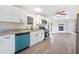 Bright kitchen with modern appliances, white cabinets, and a view into the living room at 2430 Keysville Dr, Lithia, FL 33547