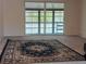 Bright living room with a patterned rug and sliding glass doors to outdoor space at 2716 Hidden Lake Blvd # C, Sarasota, FL 34237