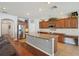 View of the kitchen featuring a large island with dark wood cabinetry and stainless appliances at 2807 Cypress Bowl Rd, Lutz, FL 33558