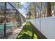 View of the backyard, fenced in with artificial turf and white gravel at 3034 Gull Pl, Clearwater, FL 33762