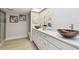 Bright bathroom with double sinks and a seamless glass shower enclosure at 3034 Gull Pl, Clearwater, FL 33762