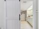 Bathroom featuring double sinks, wood-look floors, and a sliding barn door at 3034 Gull Pl, Clearwater, FL 33762